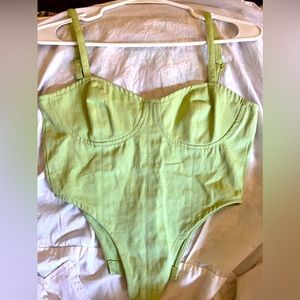 Green corset crop top with adjustable straps.
